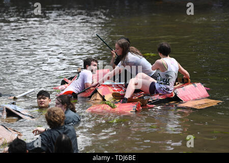 Cambridge University students in boats made from cardboard float down the River Cam in Cambridge on the Suicide Sunday, part of the annual traditions to celebrate the end of exams. Stock Photo