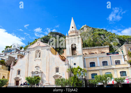 Taormina, Sicily, Italy - Apr 8th 2019: Beautiful San Giuseppe Church on Piazza IX Aprile square in the city center. Baroque style, popular tourist place. Blue sky, sunny day. Stock Photo