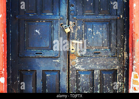 The old door is padlocked. Numerous locks installed on one single door. Stock photo Stock Photo
