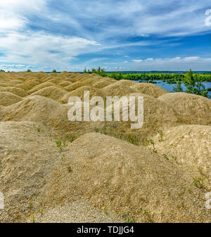 Quarries for the extraction of limestone. The embankment formed by piles of small crushed stone from limestone. Stock Photo