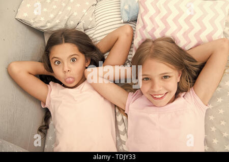 Best friends forever. Consider theme slumber party. Slumber party timeless childhood tradition. Girls relaxing on bed. Slumber party concept. Girls just want to have fun. Invite friend for sleepover. Stock Photo