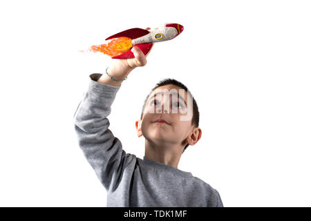 Child plays with a rocket. Concept of imagination. Isolated on white background Stock Photo