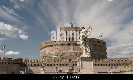 low angle shot of an angel statue on bridge with castel santangelo, rome in the background Stock Photo