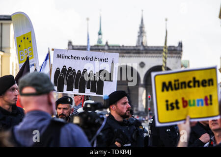 Munich, Bavaria, Germany. 17th June, 2019. A anti-Islam sign on the left held by a far-rightist contrasts with a ''Munich is Diverse sign on right with the Feldherrnhalle in the background where Hitler rose to power. Headed by the Verfassungsschutz (Secret Service) monitored Michael Stuerzenberger, the Buergerbewegung Pax Europa (Citizen Initiative Pax Europa) islamophobic group marched through the University area of Munich, Germany. Credit: ZUMA Press, Inc./Alamy Live News Stock Photo