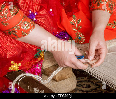 Iranian Hill Tribe Woman Waves Tapestry - Close-up. Stock Photo