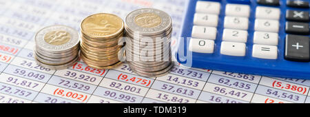 Coins on spreadsheet report to calculate profits Stock Photo
