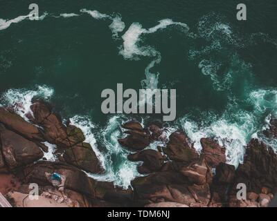 An Amazing Shot Of Rocky Beach With Splashing Sea Waves Crashing 