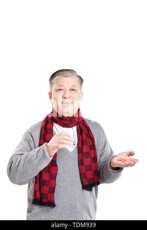 portrait old Asian in sweater taking medicine Stock Photo
