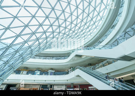 side of glass building and escalator in modern hall Stock Photo