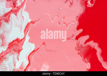 Fluid Art. Mixing red, white and pink acrylic paints. Abstract marble background or texture. Stock Photo