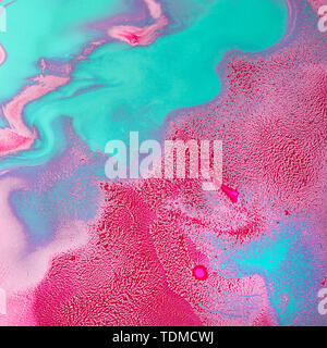 Acrylic Fluid Art. Glowing turquoise red curls and waves. Abstract modern background or texture. Stock Photo