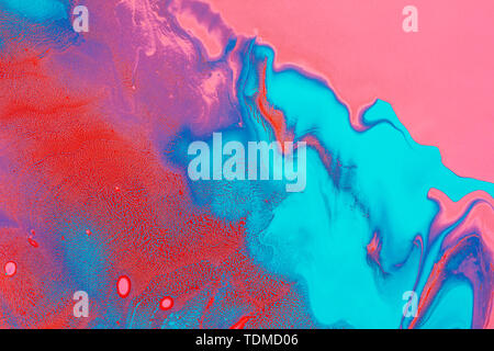 Acrylic Fluid Art. Glowing pink red waves and blue curls. Abstract neon background or texture. Stock Photo