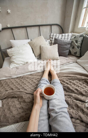 Crop woman having breakfast on bed Stock Photo