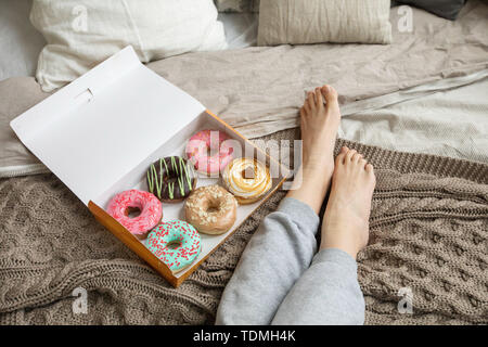 Crop woman having breakfast on bed Stock Photo