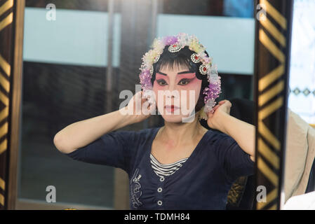 Traditional Chinese actress, applies makeup before a performance in a Chinese theatre. Photographed in Chengdu, Sichuan, China Stock Photo