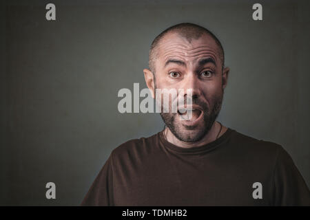 studio portrait of man with surprised expression. Short hair and beard. Stock Photo
