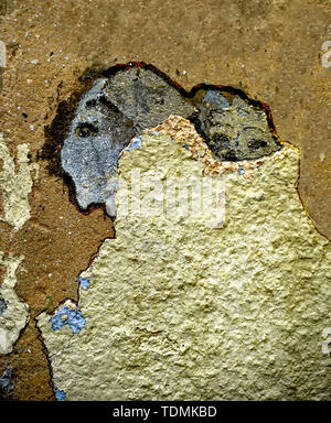 Paint and plaster peeling off a wall the result looks like an abstract artwork woman carrying a baby on her back Stock Photo