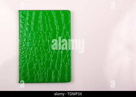 Green notebook on white background. Closed diary Stock Photo