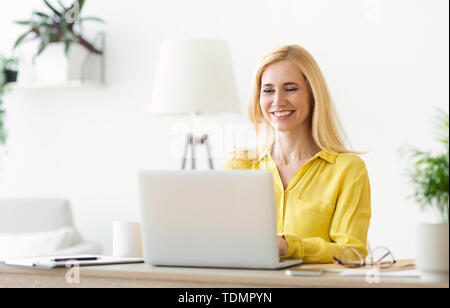 Successful Mature Businesswoman Using Laptop, Working In Office Stock Photo