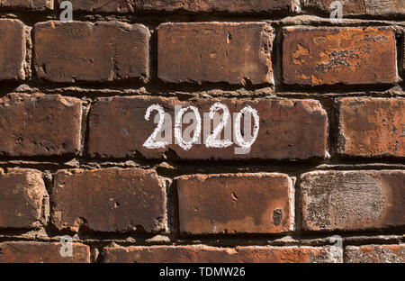 Handwritten white text on red bricks wall outdoor Stock Photo