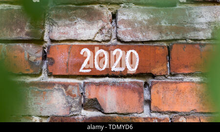 2020 concept on old bricks building, view from the bushes Stock Photo