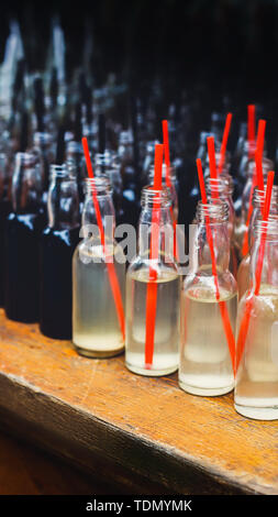 Set of many alcohol tasty shots with straws in small bottles Stock Photo