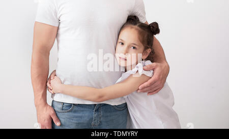 Sad daughter hugging her father, difficulties between parents and children Stock Photo