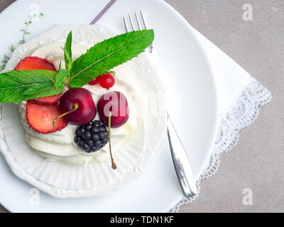 Pavlova meringue cake with fresh berries on white plate, top view Stock Photo