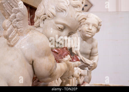 CATANIA, ITALY - APRIL 7, 2018: The angels and baroque marble stoup in Chiesa di San Nicolo. Stock Photo