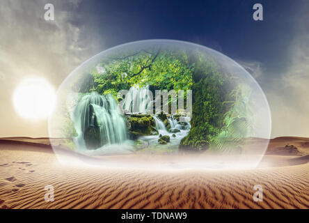 Glass dome with natural scenery and waterfalls in a desert landscape Stock Photo