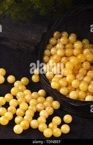 Beeswax, amber beads, beads. Stock Photo