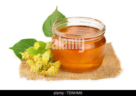 Honey with linden flowers isolated on white background. Stock Photo