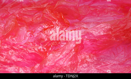 Red Plastic Bag Texture. Abstract Wrinkled Background of Plastic Garbage Stock Photo