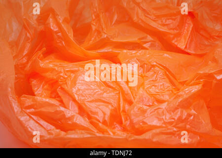 Orange Color Plastic Bag Texture. Abstract Wrinkled Background of Plastic Garbage Stock Photo
