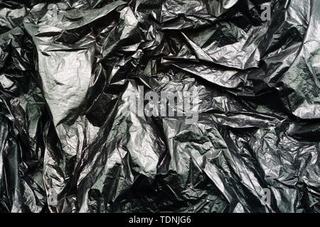 Black Plastic Garbage Bag Texture. Abstract Wrinkled Background of Plastic Garbage Stock Photo