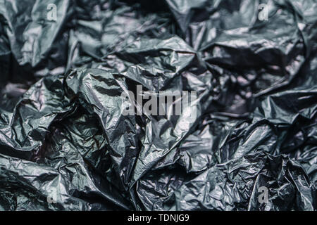 Black Plastic Garbage Bag Texture. Abstract Wrinkled Background of Plastic Garbage Stock Photo