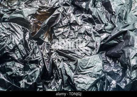 Black Plastic Garbage Bag Texture. Abstract Wrinkled Background of Plastic Garbage Stock Photo