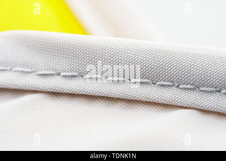 Finishing seam of a sports backpack close-up shot. Sport nylon fabric texture Stock Photo