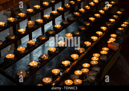 Prayer candles burning in a Jezus szive templom church, Koszeg, Hungary Stock Photo