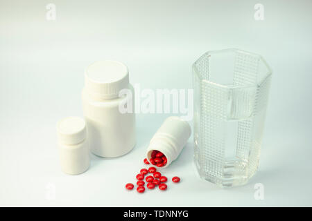 Medicine and water cup in white background Stock Photo