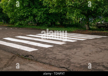 Zebra crossing in the city. Detail of a crosswalk on a road, asphalt and safety Stock Photo