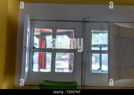Looking through 100 year old white windows on sunny day Stock Photo