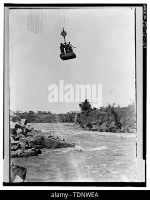 Photocopy of Photograph (original in Roger Lewis' private collection). Photographer and date unknown. MILNER DAM, TWIN FALLS COUNTY, MILNER, IDAHO; NORTH DAM, WORKERS RIDE LOADING-DUMPING CAR DEVICE. - Milner Dam and Main Canal- Twin Falls Canal Company, On Snake River, 11 miles West of city of Burley, Idaho, Twin Falls, Twin Falls County, ID Stock Photo