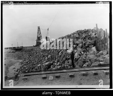 Photocopy of Photograph (original in Roger Lewis' private collection). Photographer and date unknown. MILNER DAM, TWIN FALLS COUNTY, MILNER, IDAHO; UNLOADING ROCK ONTO MILNER DAM, WOODEN CORE IN FOREGROUND. - Milner Dam and Main Canal- Twin Falls Canal Company, On Snake River, 11 miles West of city of Burley, Idaho, Twin Falls, Twin Falls County, ID Stock Photo