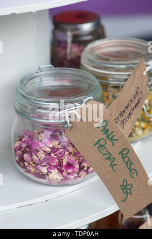 Dried pink rose petals in a jar at a flower show. UK Stock Photo