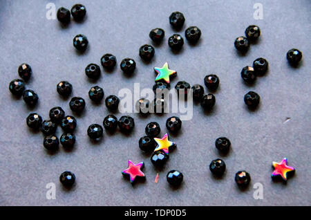 Colorful, black beads and stones isolated on white and grey background Stock Photo