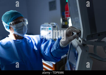 Female surgeon using monitor in operation theater Stock Photo