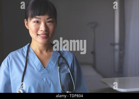 Happy female doctor standing in hospital Stock Photo