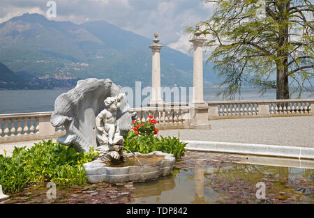 BELAGGIO, ITALY - MAY 10, 2015: The Villa Melzi on the waterfront of Como lake and the little fountain in the gardens. Stock Photo