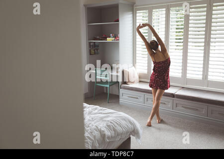 Woman stretching hand at morning in bedroom at home Stock Photo